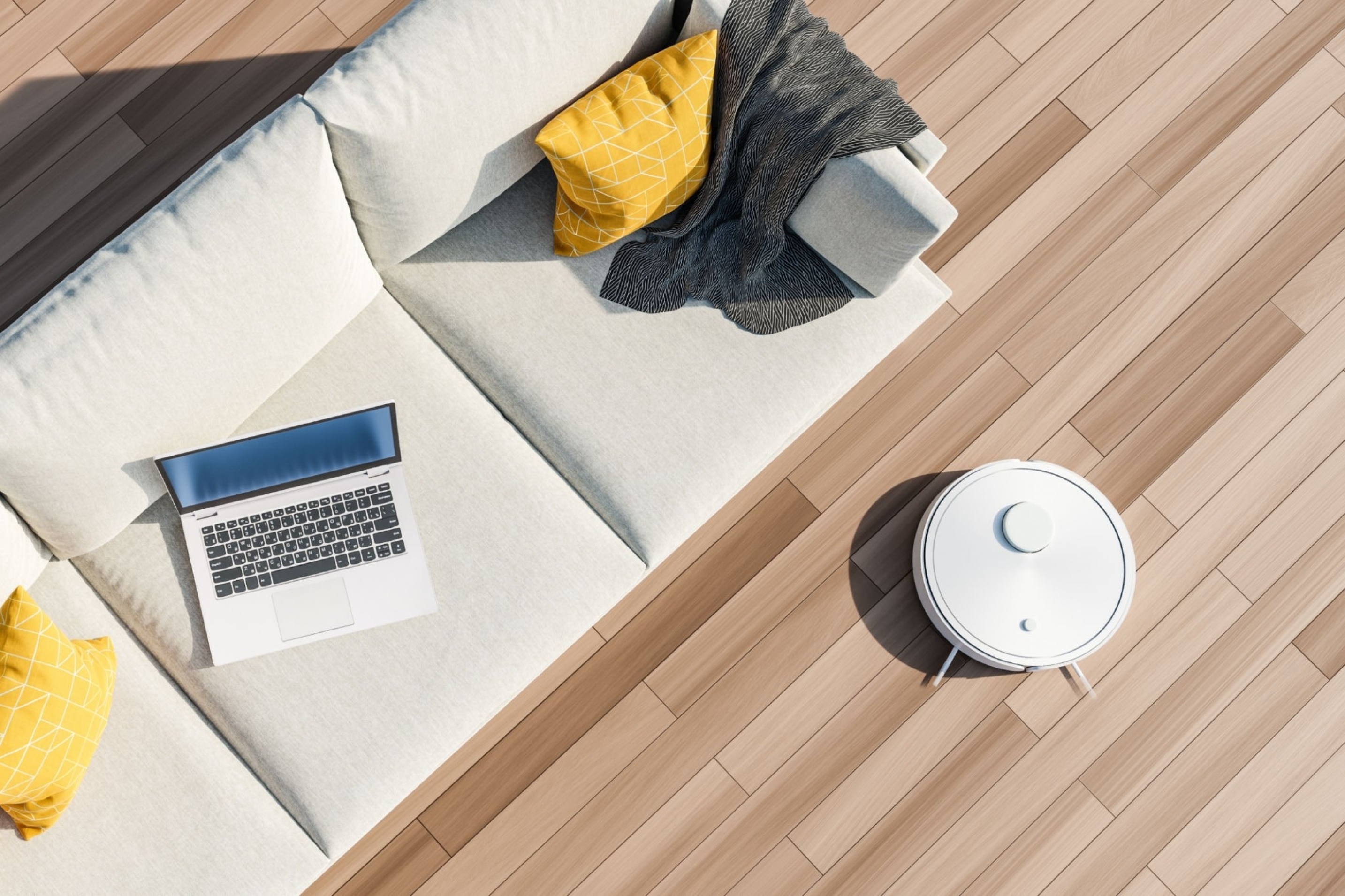 Top view of a sofa with laptop and yellow cushions